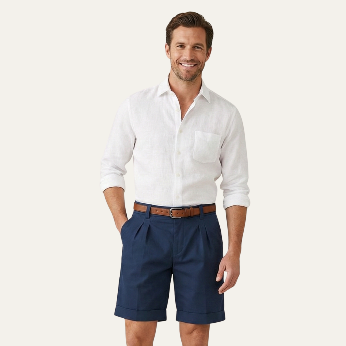 Smiling man wearing navy pleated turn-up shorts with a tan belt and a white linen shirt with chest pocket. 8