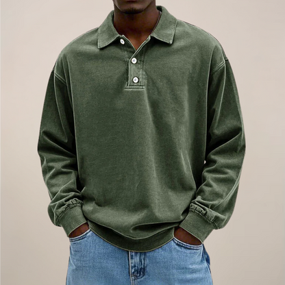 Front view of the polo in washed olive green with a three-button placket, worn by a model with light jeans. 2