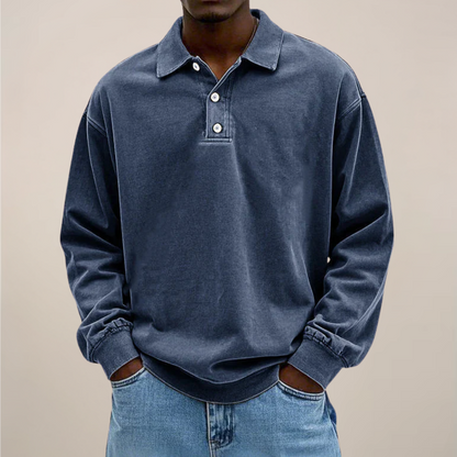 Model wearing the polo in washed dark slate blue, front view showing the collar, buttons and dropped shoulders. 5