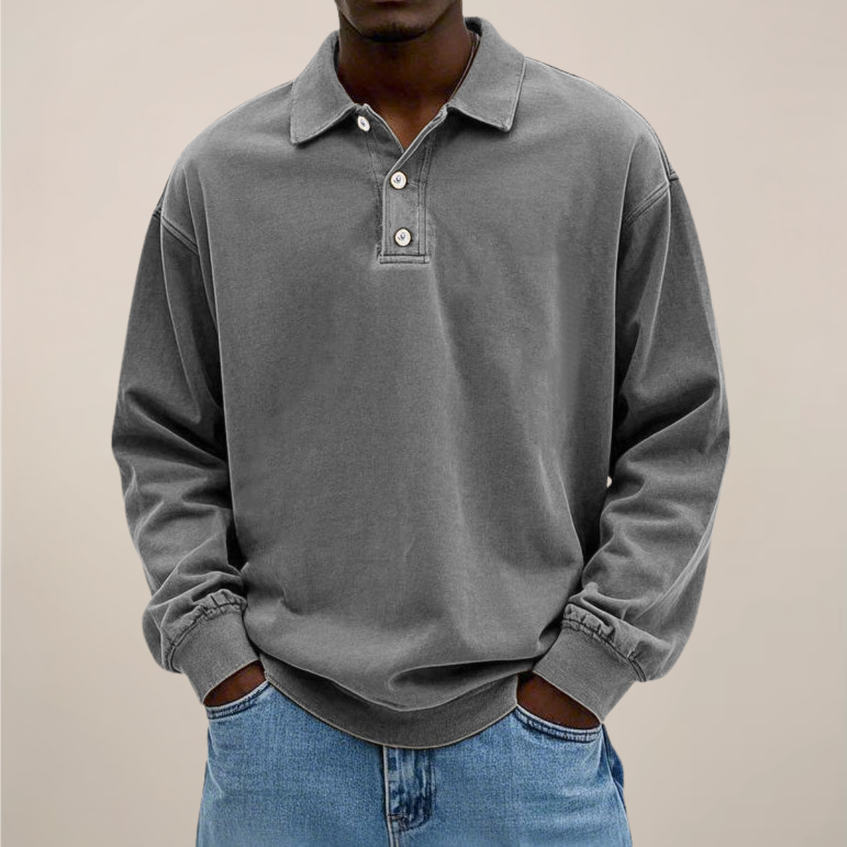 Model wearing the long sleeve polo in washed mid grey, front view with collar, button placket and ribbed cuffs. 7
