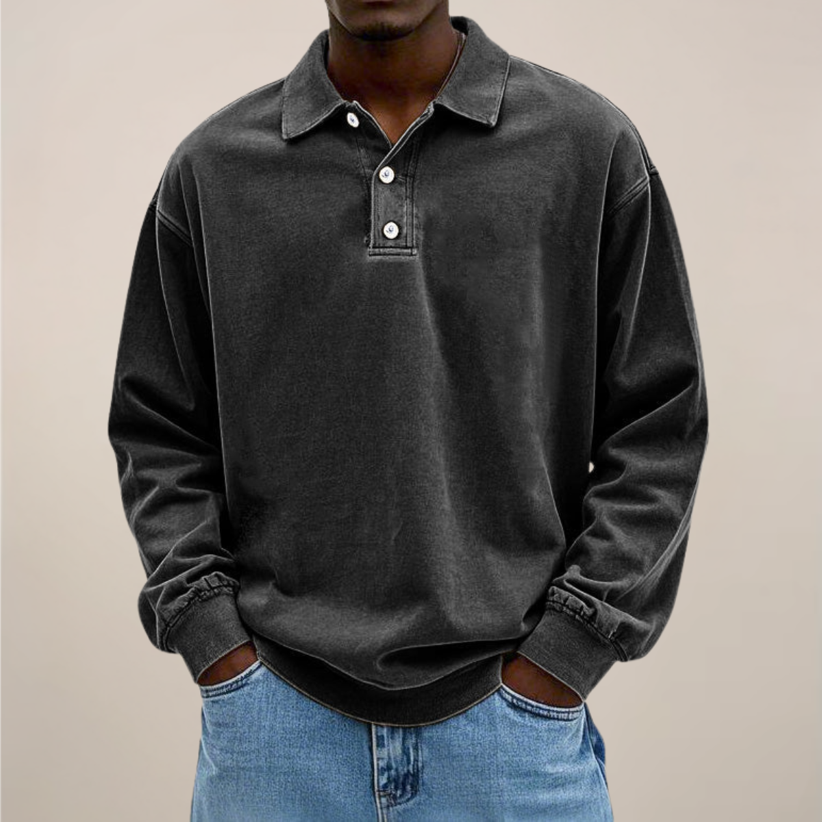 Front view of the polo in washed charcoal black, worn with light blue jeans, showing the relaxed fit and ribbed hem. 8
