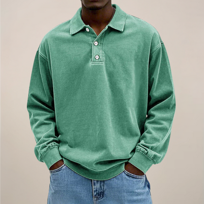 Model wearing the washed polo in soft mint green, front view, with buttoned placket and loose sleeves. 9