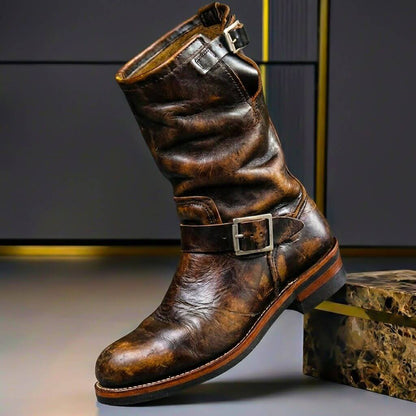 Distressed dark brown leather engineer boot with a slouched shaft, silver-toned buckles and visible scuffing. 4