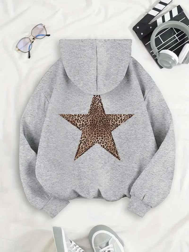 Grey marl hoodie laid flat on a white sheet, back facing up to show the leopard-print star, with glasses, headphones and trainers. 2