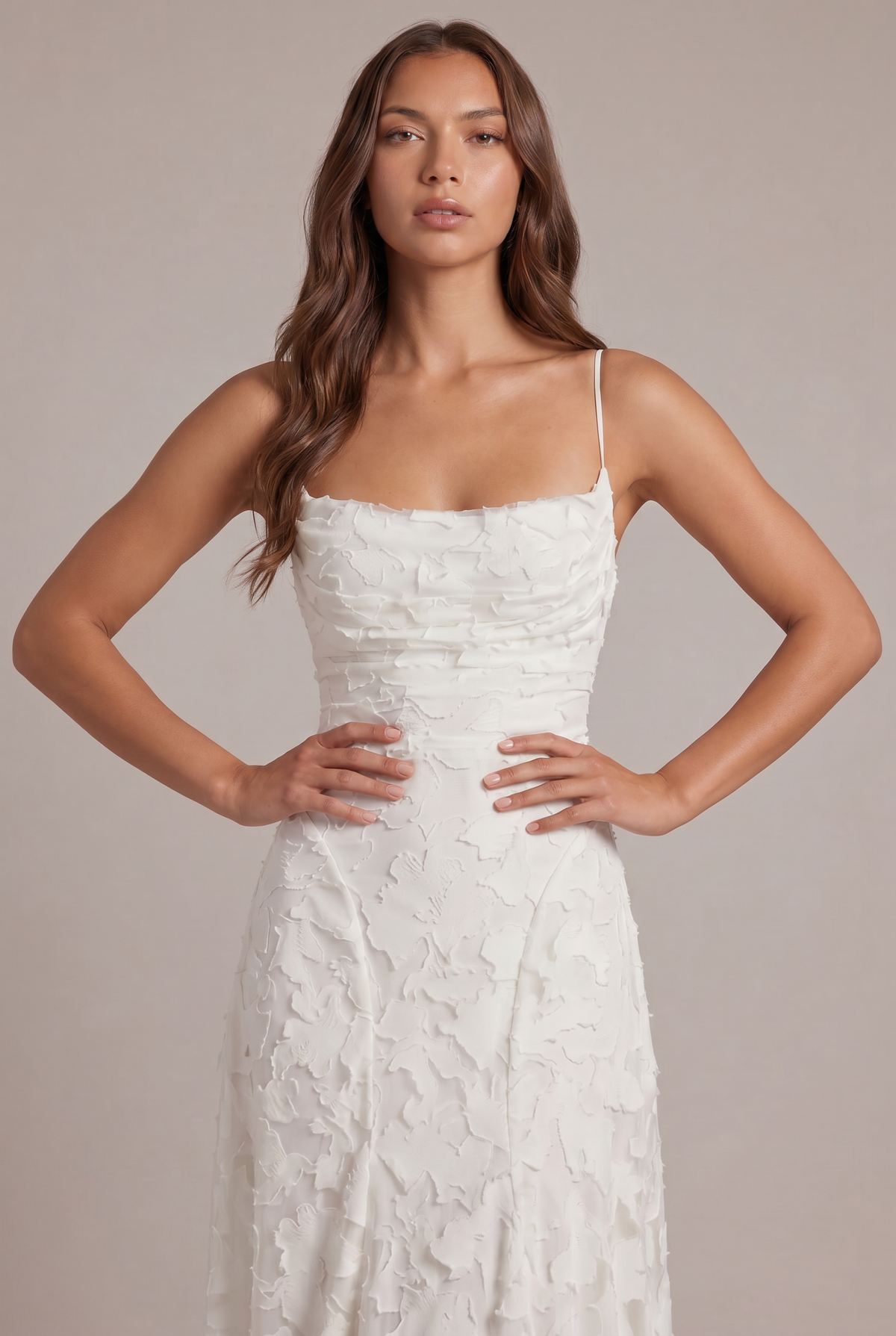 Close-up of the white dress bodice on a model with hands on hips, showing the draped neckline and floral texture. 10