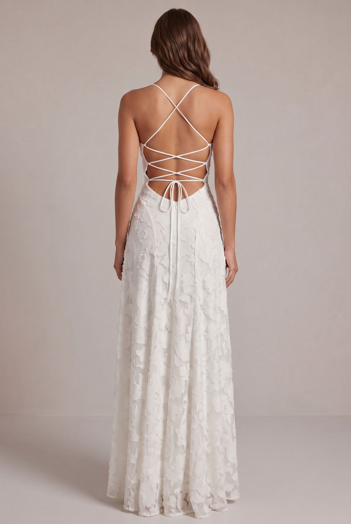 Back view of the white maxi dress, showing the criss-cross lace-up open back, tie closure and zip. 11