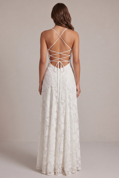 Back view of the white maxi dress, showing the criss-cross lace-up open back, tie closure and zip. 11
