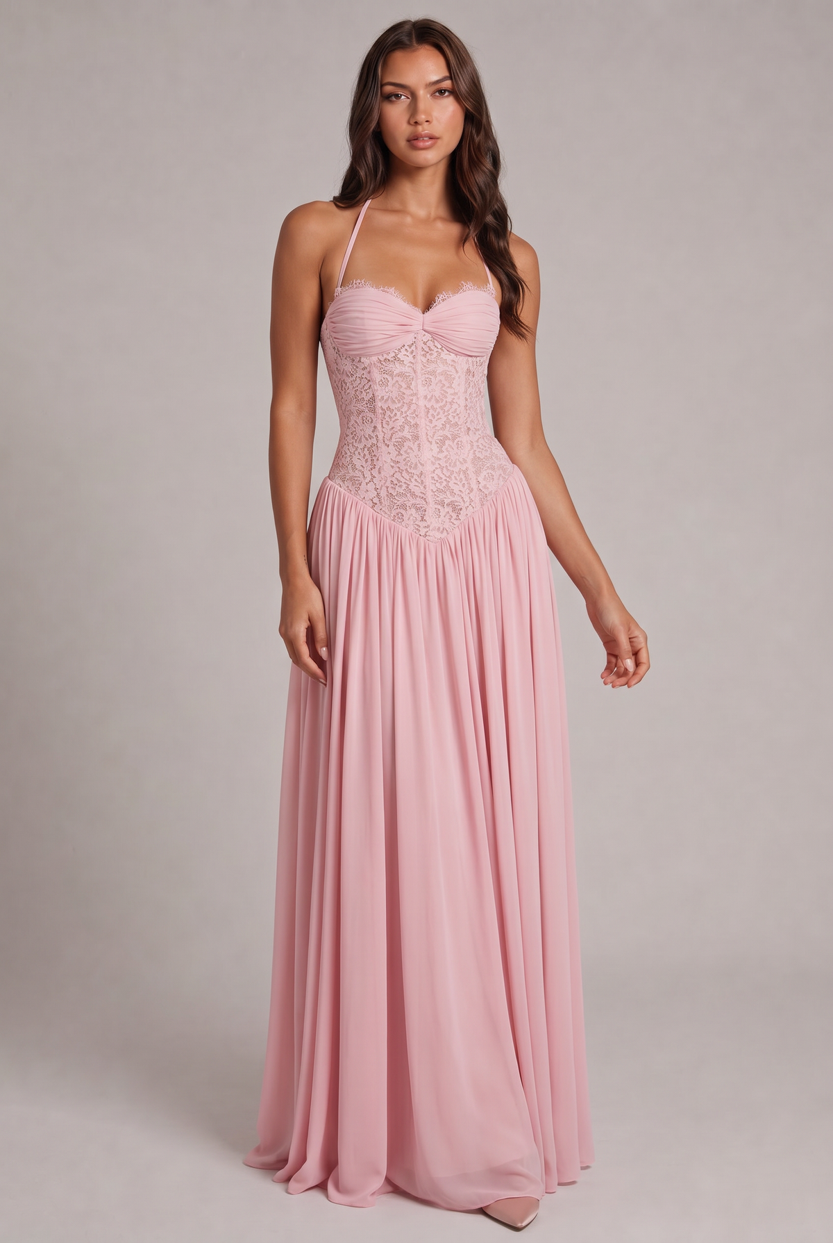 Model facing the camera in the pink halterneck maxi dress, showing the lace corset bodice and long flowing chiffon skirt. 1