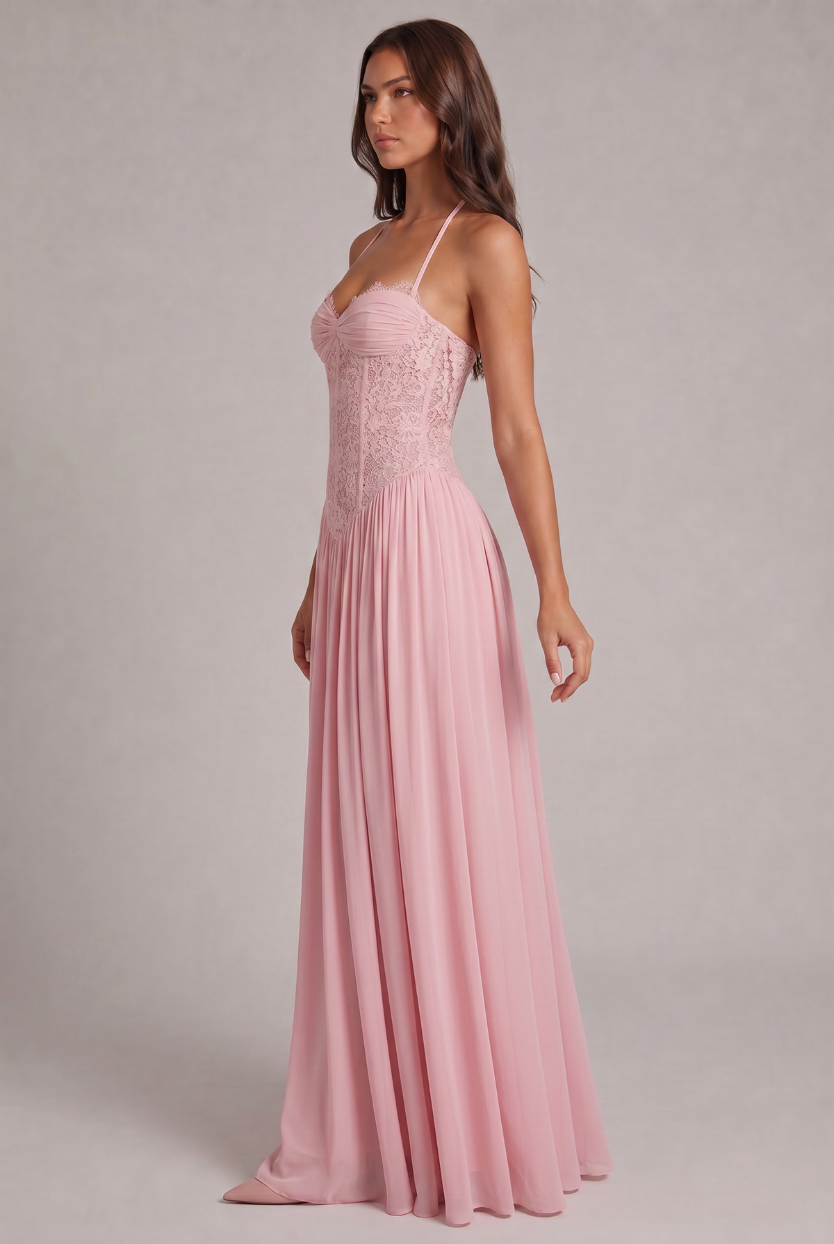 Side view of the pink maxi dress worn by a model, showing the halter straps and gathered chiffon skirt. 3