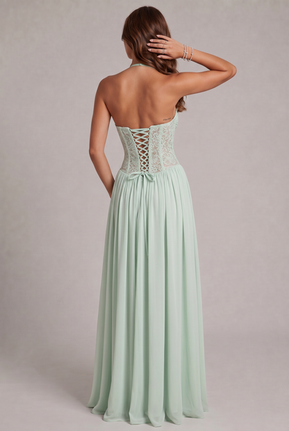 Back view of the mint green dress on a model, showing the lace-up corset back, bow and open back. 11