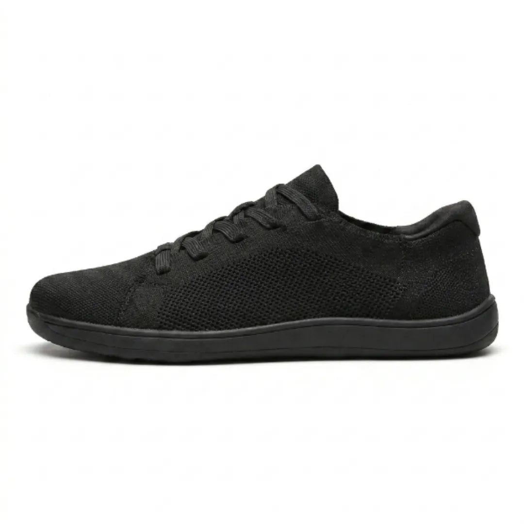 Side view of an all-black knit lace-up trainer with a mesh panel and a flat black sole. 10