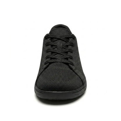 Front view of a black knit trainer showing the laces, rounded wide toe box and flat black sole. 17