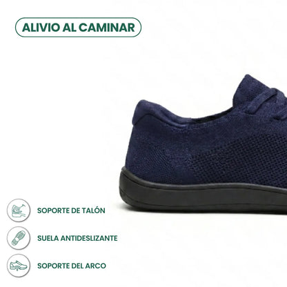 Close-up of the heel and side of a navy knit trainer with black sole, with small feature icons beneath. 22