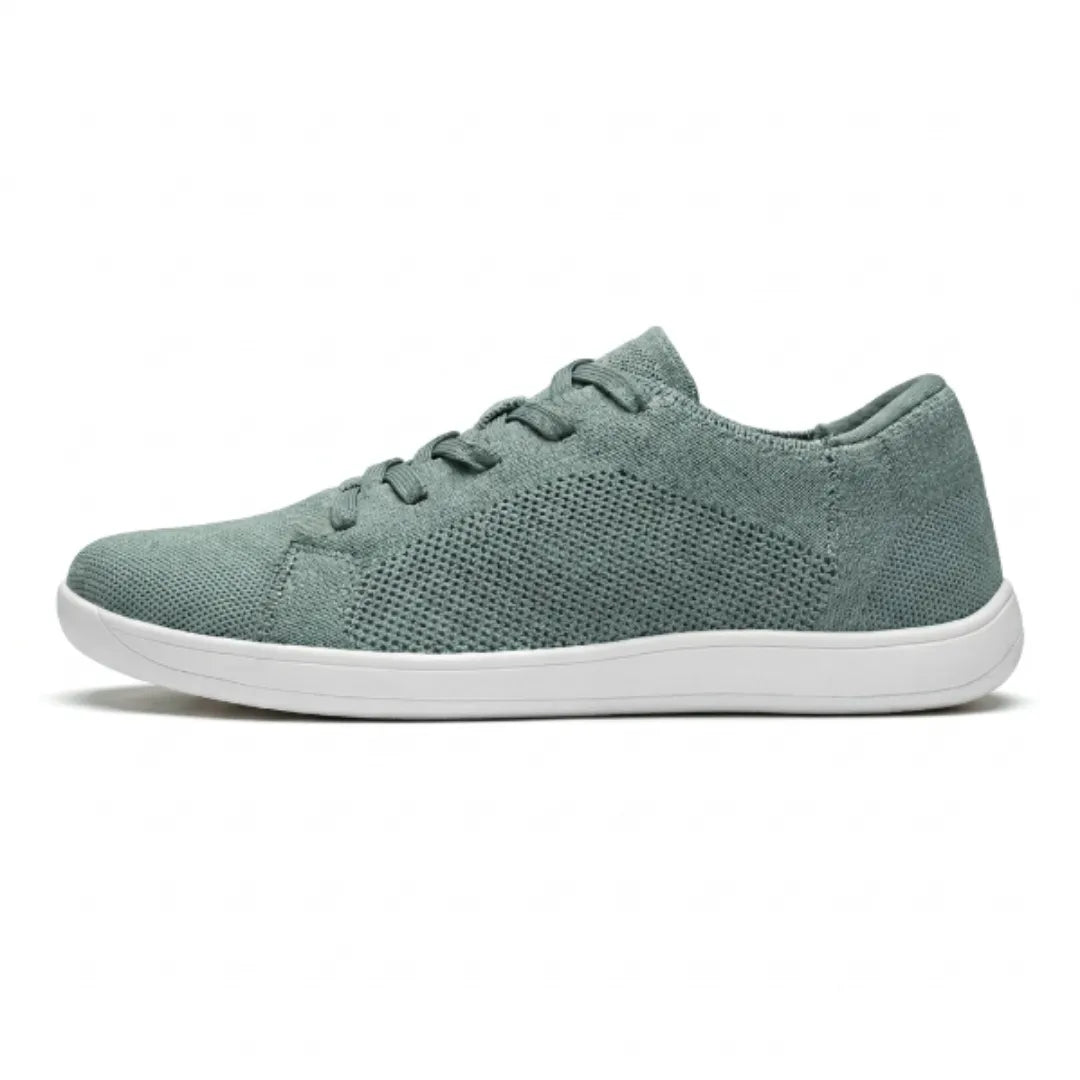 Sage green knit trainer with white sole, side profile showing the perforated mesh panel and laces. 28