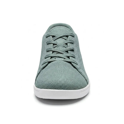 Sage green knit trainer seen from the front, showing criss-cross laces, rounded toe and flat white sole. 35