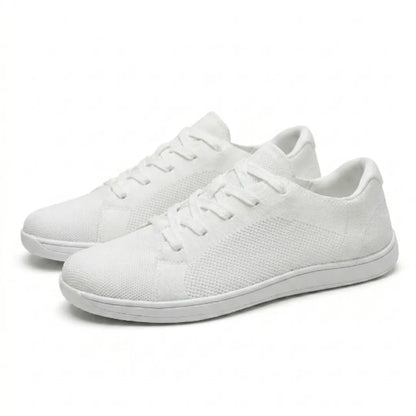 Pair of white knitted mesh lace-up trainers with thin white soles, shown at a three-quarter angle on a plain background. 43