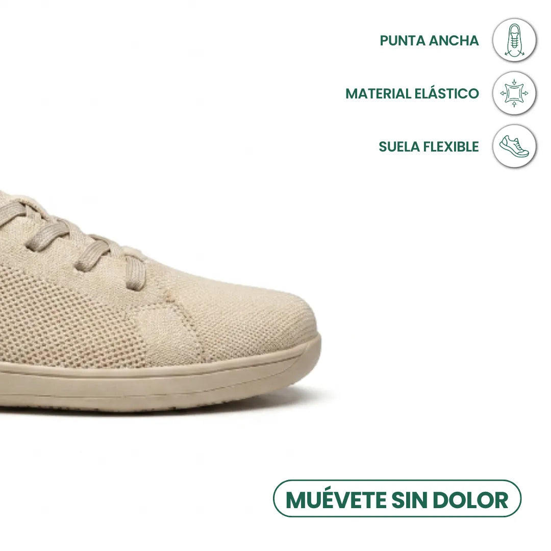Close-up of the wide toe of a beige trainer beside a Spanish infographic on toe room, stretch fabric and flexible sole. 5
