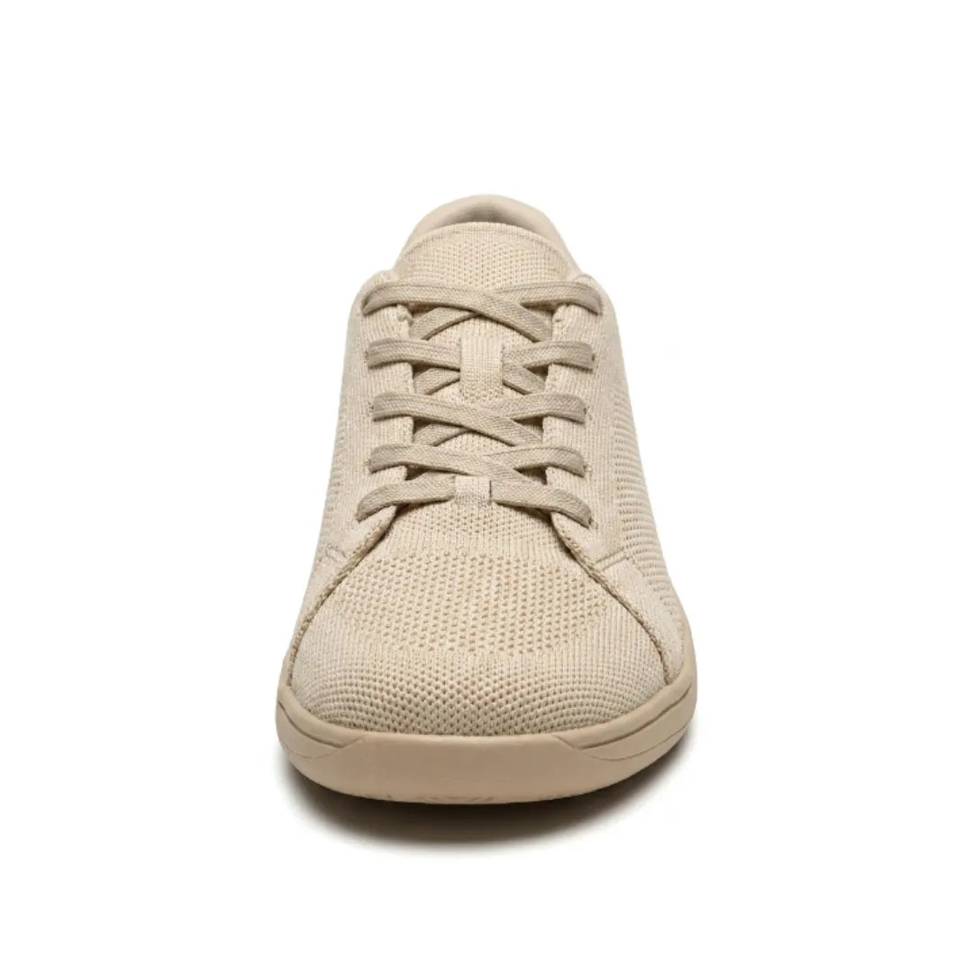Front view of a beige knit trainer showing the laces, rounded wide toe box and flat sole. 8