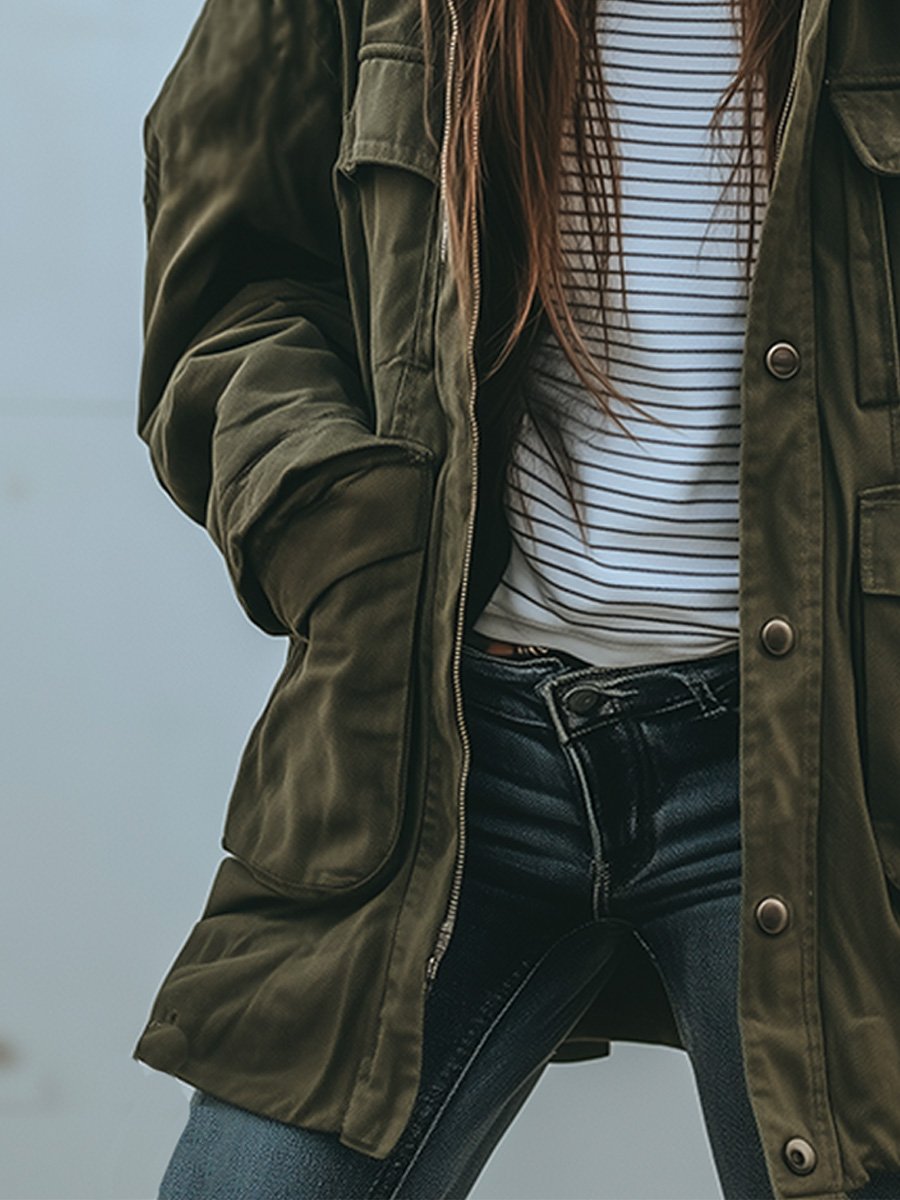 Close-up of the zip, snap-button placket and roomy lower pocket, with the jacket worn open over a striped top. 4