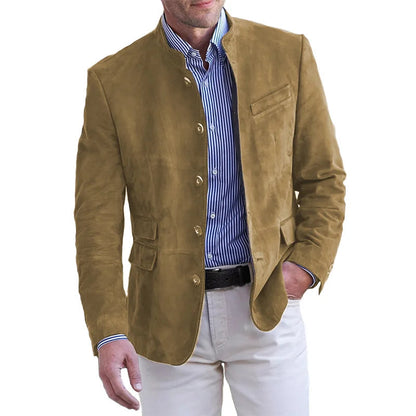 Man wearing the stand-collar button-front jacket in tan brown over a blue striped shirt and cream trousers, hand in pocket. 5