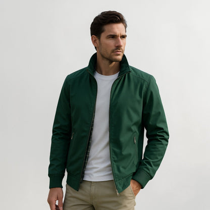 Model wearing the jacket in dark green over a white t-shirt with khaki trousers, a checked lining visible at the open front. 3