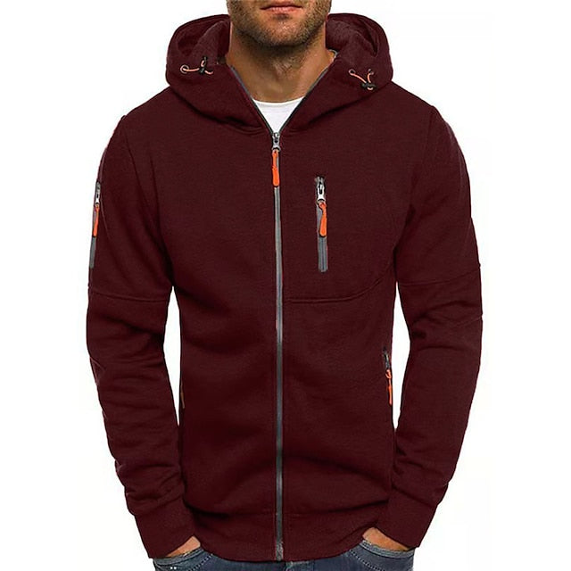 Front view of the burgundy zip-up hoodie on a model, with orange zip pulls and a grey front zip. 7