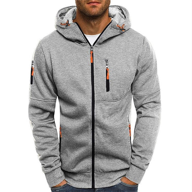 Model wearing the light grey zip-up hoodie from the front, with orange zip pulls and contrasting black zip tape. 8