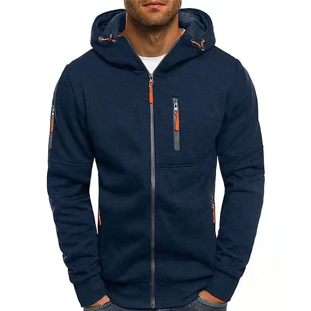 Front view of the navy blue zip-up hoodie on a model, with orange zip pulls and a zipped chest pocket. 9
