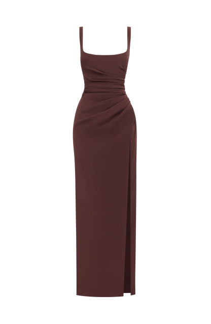 Brown maxi dress shown alone on a white background, with square neckline, ruched waist and side slit. 9