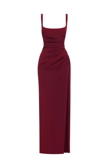 Burgundy dress shown flat on a plain white background, with wide straps, ruched waist and a high side slit. 23
