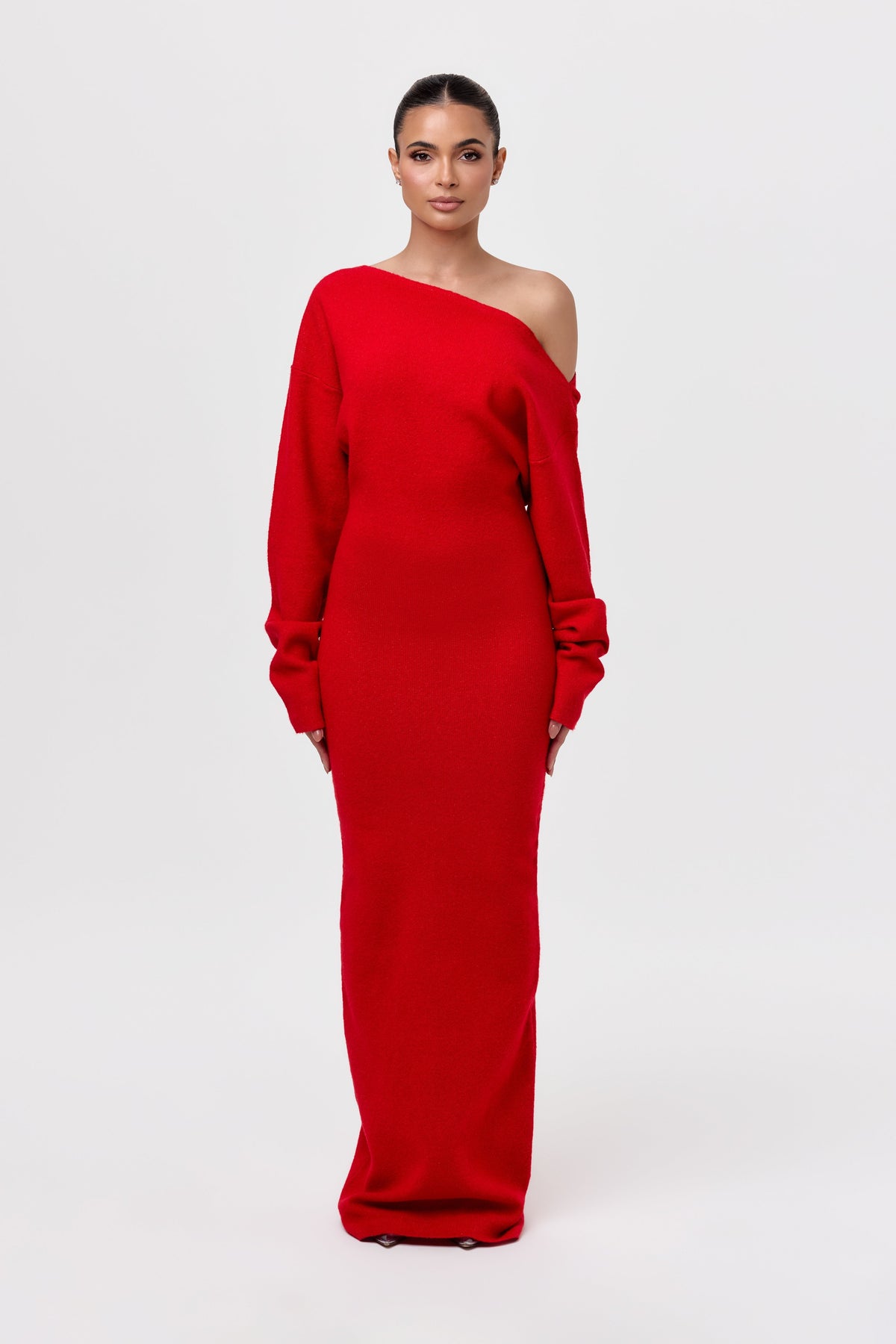Model facing the camera in a red off-the-shoulder knit maxi dress with long sleeves and a fitted floor-length skirt. 21