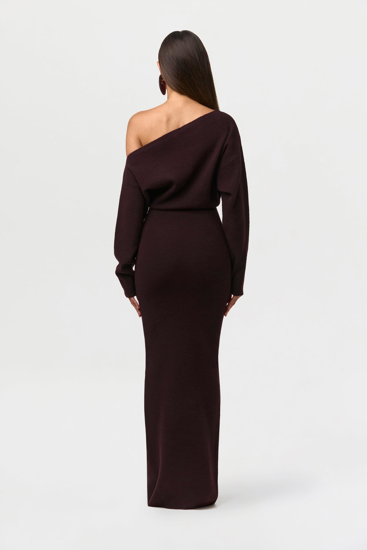 Back view of the deep burgundy-brown knit maxi dress, showing the off-shoulder shape and fitted skirt. 20