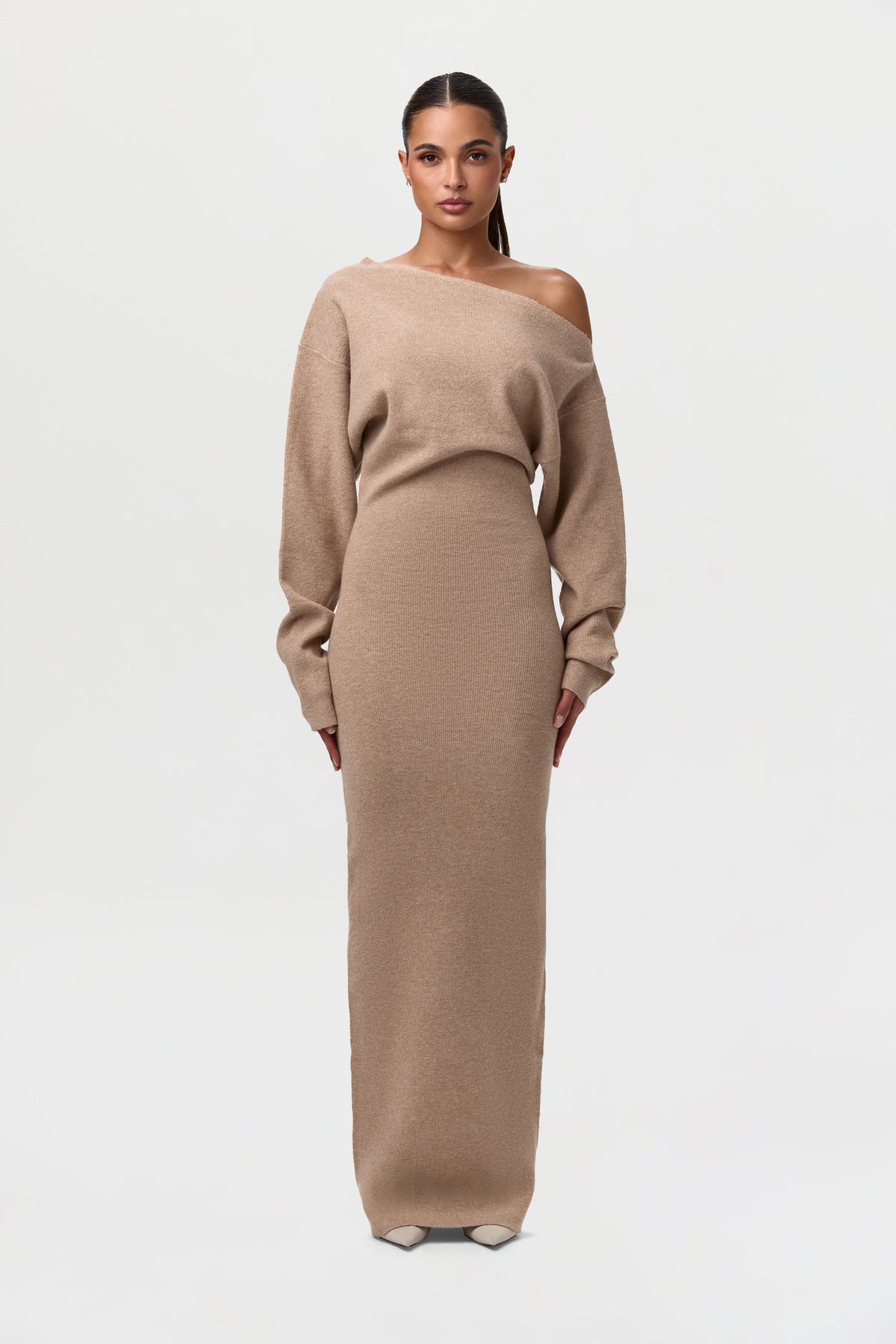 Model facing forward in the camel-coloured off-the-shoulder knit maxi dress with a fitted ribbed skirt. 15