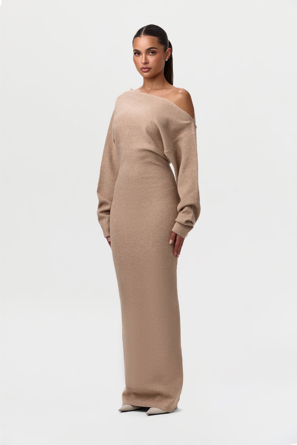 Three-quarter view of the camel knit maxi dress, showing the bare shoulder and relaxed sleeves. 16