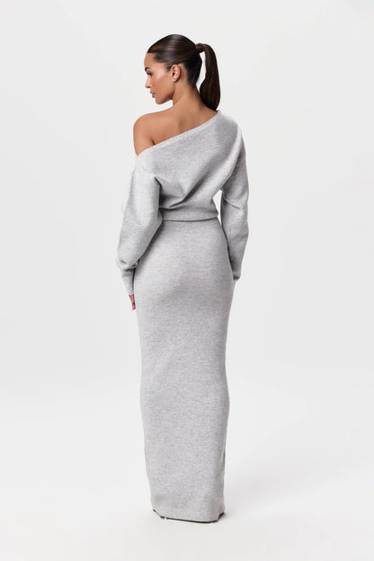 Back view of the light grey knit maxi dress, showing the bare shoulder and fitted skirt. 11