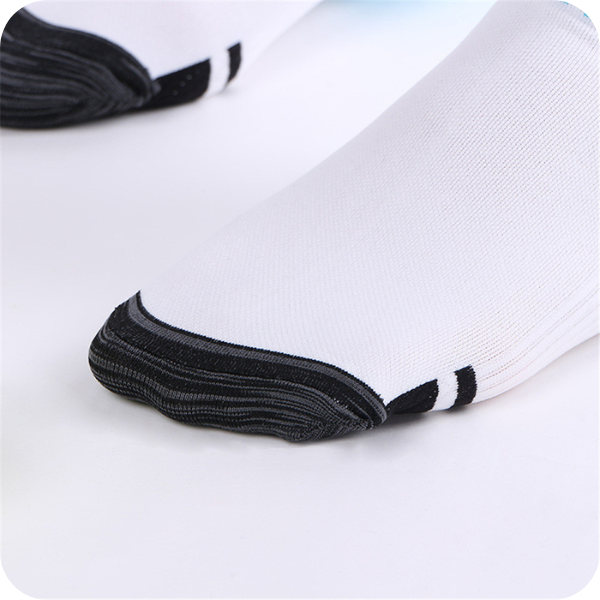Close-up of the dark reinforced toe of a white sock, with two black stripes beside the toe cap. 4
