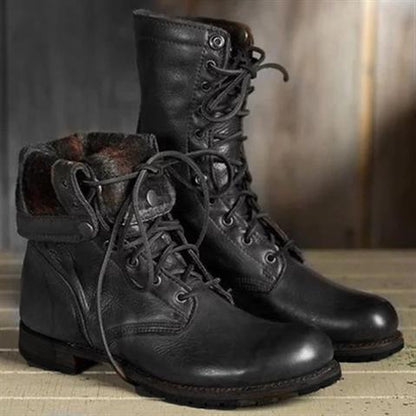 Pair of black leather lace-up boots, one with its patterned lined cuff folded down, shown from the front and side. 2