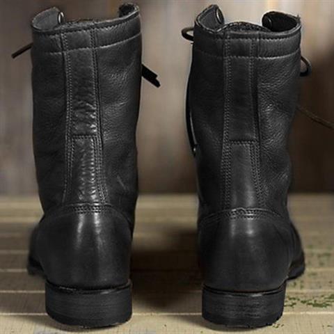 Back view of a pair of black leather boots, showing the vertical seam down the heel and the low block heels. 4