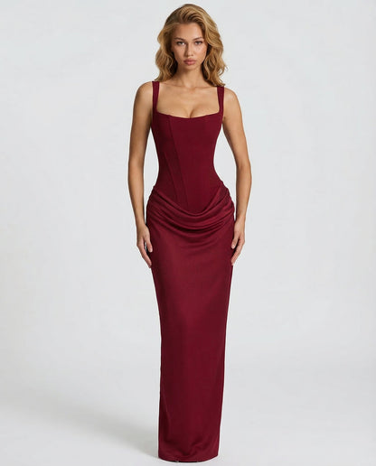 Front view of the deep red dress on a model with wavy hair, showing the boned bodice and draped hip detail. 12