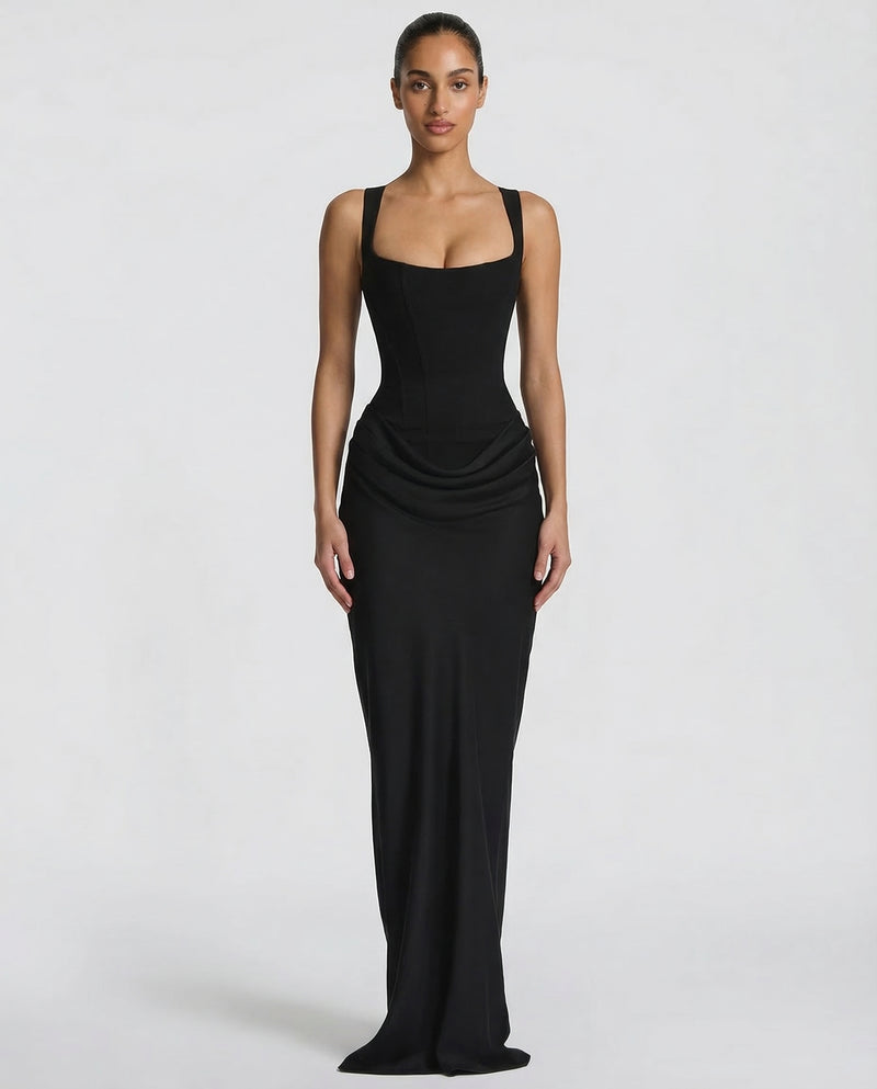 Black maxi dress with a structured square-neck corset bodice and draped hip detail, shown full-length from the front on a model. 1