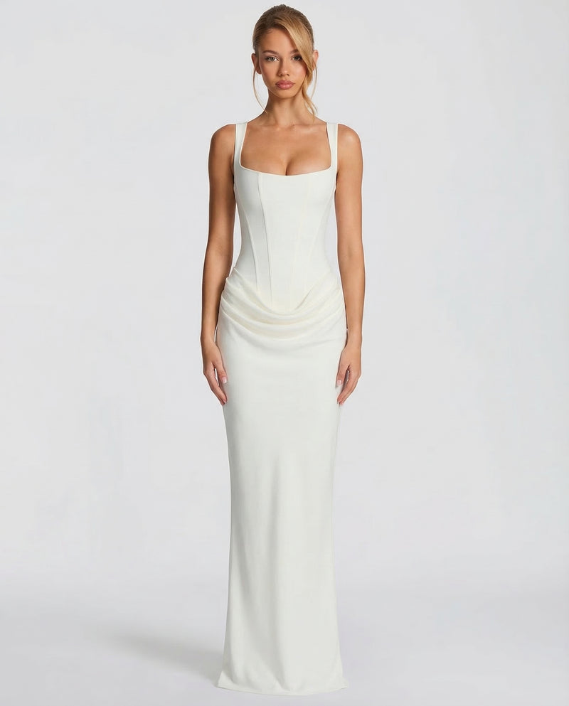 Front view of the ivory dress on a model, with a seamed corset bodice, square neckline and draped hip detail. 5