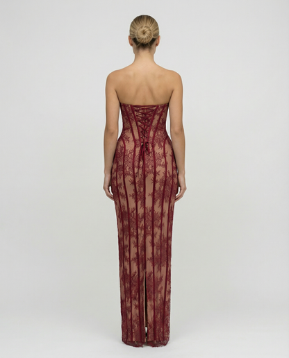 Back view of the burgundy lace dress, showing the corset-style lace-up back with a bow and the centre slit at the hem. 2