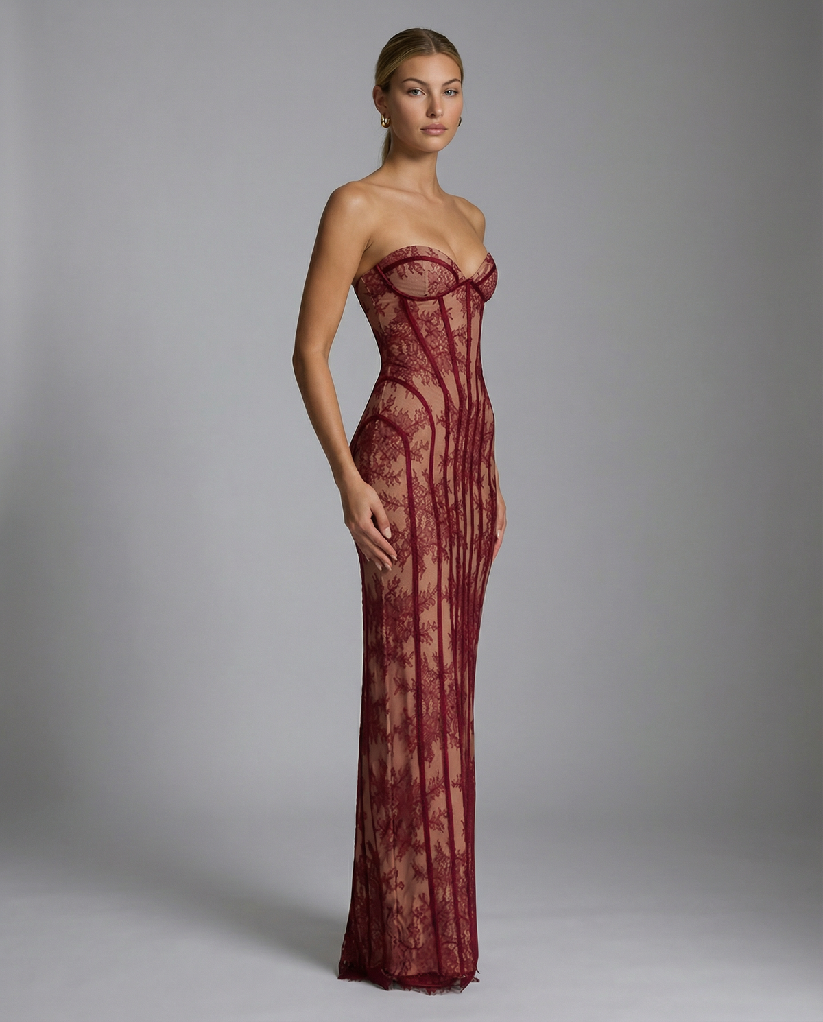 Side view of the burgundy lace dress, showing the sweetheart neckline, curved seams at the hip and long column skirt. 4