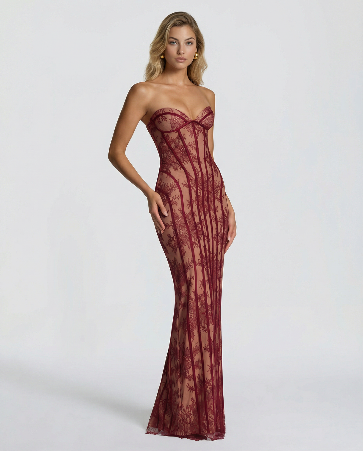 Three-quarter view of the burgundy lace dress on a model with wavy hair, showing the fitted shape and floral lace over a nude lining. 3