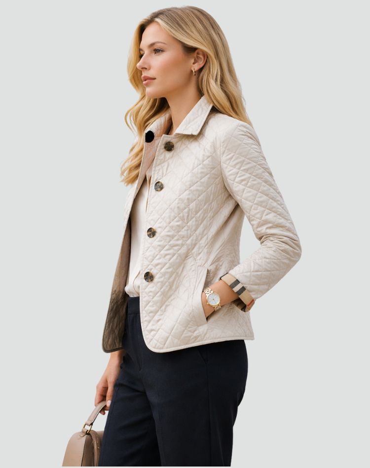 Side view of the cream quilted jacket worn by a model, showing the diamond stitching, front buttons, pocket and check cuff. 7