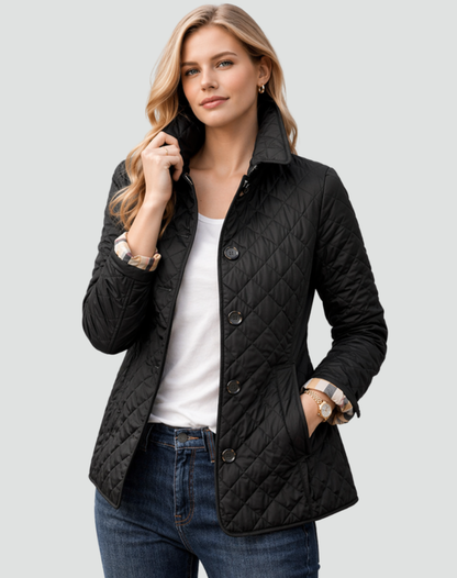 Model wearing the black diamond-quilted jacket buttoned over a white tee and jeans, one hand in the pocket, check cuff turned back. 1