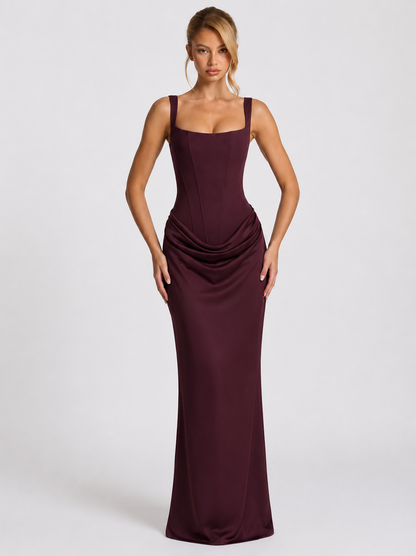 Straight-on front view of the plum dress, showing the square-neck corset bodice, wide straps and draped hip over the long skirt. 16