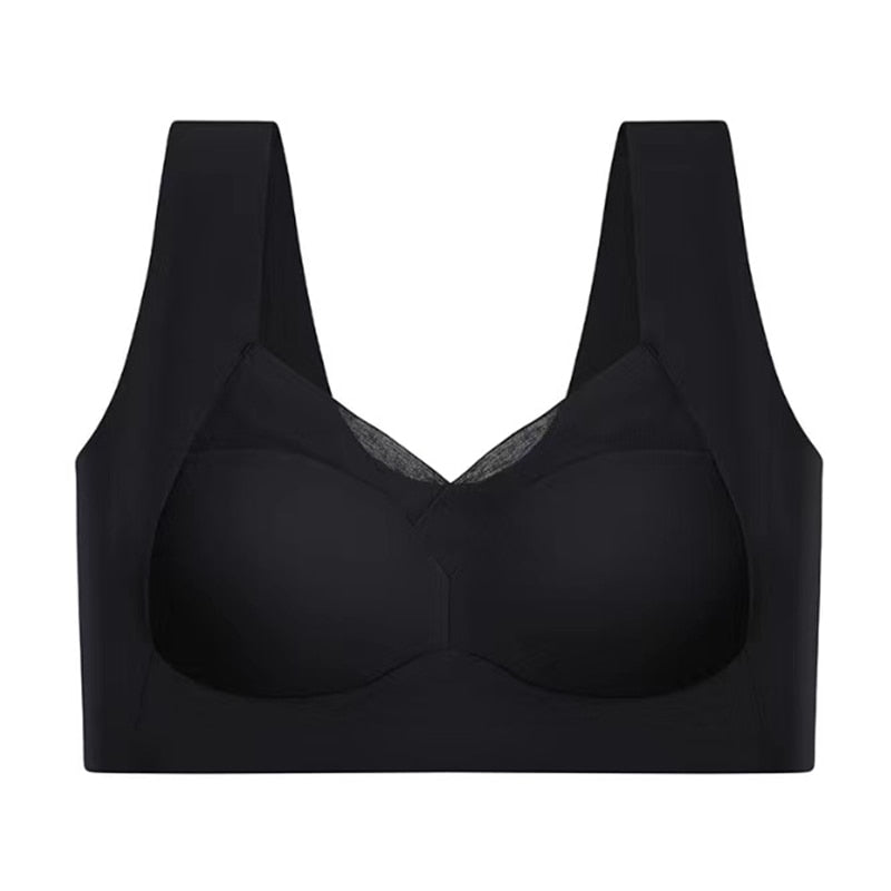 Black seamless bra laid flat against a white background, showing the mesh neckline panel, wide straps and smooth cups. 11