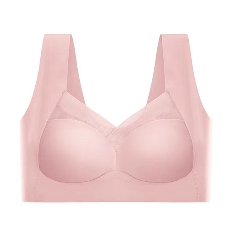 Pink seamless bra laid flat against a white background, showing the mesh neckline panel, wide straps and smooth cups. 8