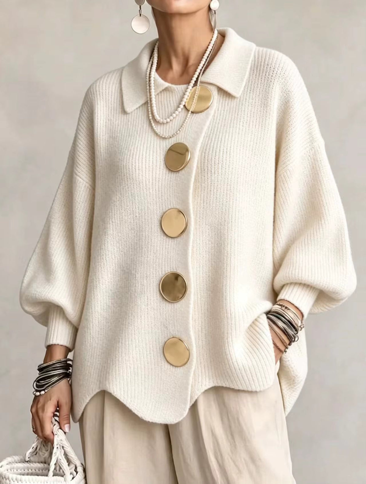 Cream version worn by a model, front view with large gold buttons, ribbed knit collar and loose balloon sleeves. 5